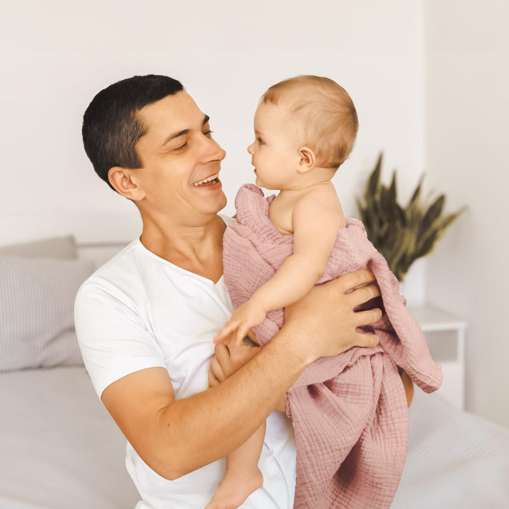 Lulumoon Muslin Swaddle Blanket doubles as sun shield on stroller outdoors.