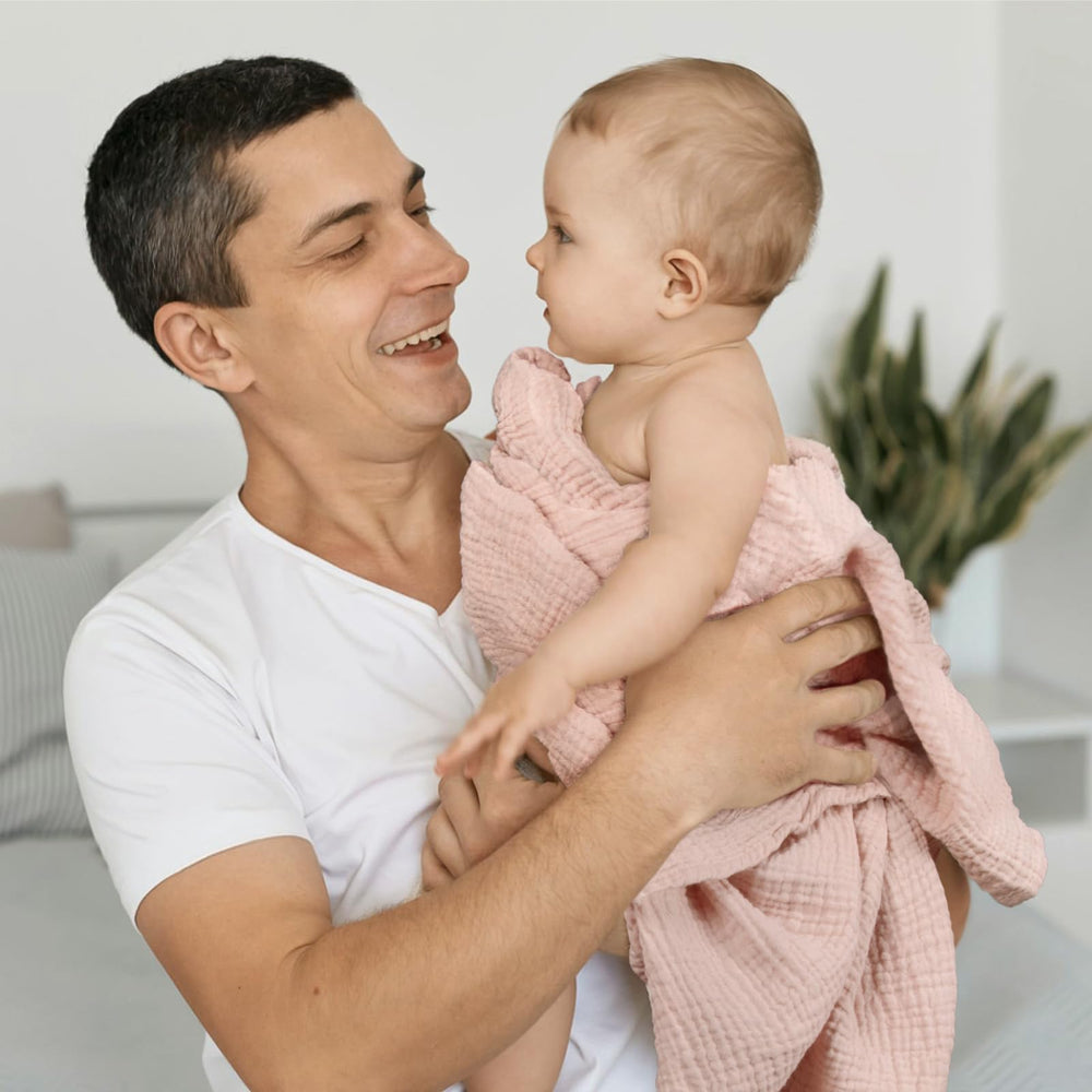 lulumoon Muslin Swaddle Chestnut-changing-table-use highlights easy on-the-go comfort during diaper changes