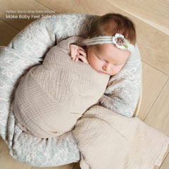 lulumoon muslin swaddle olive wrapped baby sleeping aid with gentle snugness.