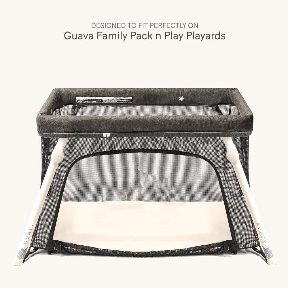 lulumoon snug-fit elastic-edge sheets secure a Guava Family Pack n Play during movement.