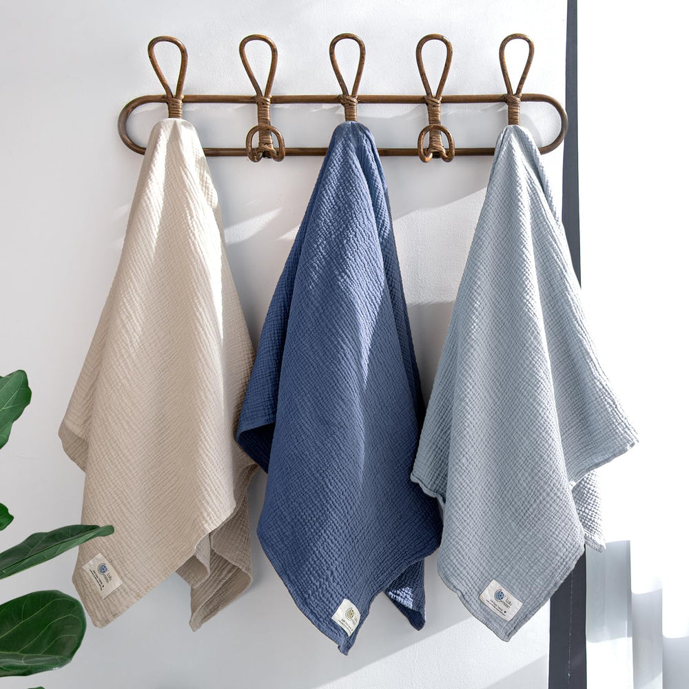 lulumoon muslin swaddle navy bundle in use soothing baby arms