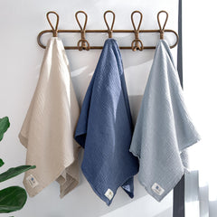 lulumoon muslin swaddle navy bundle in use soothing baby arms
