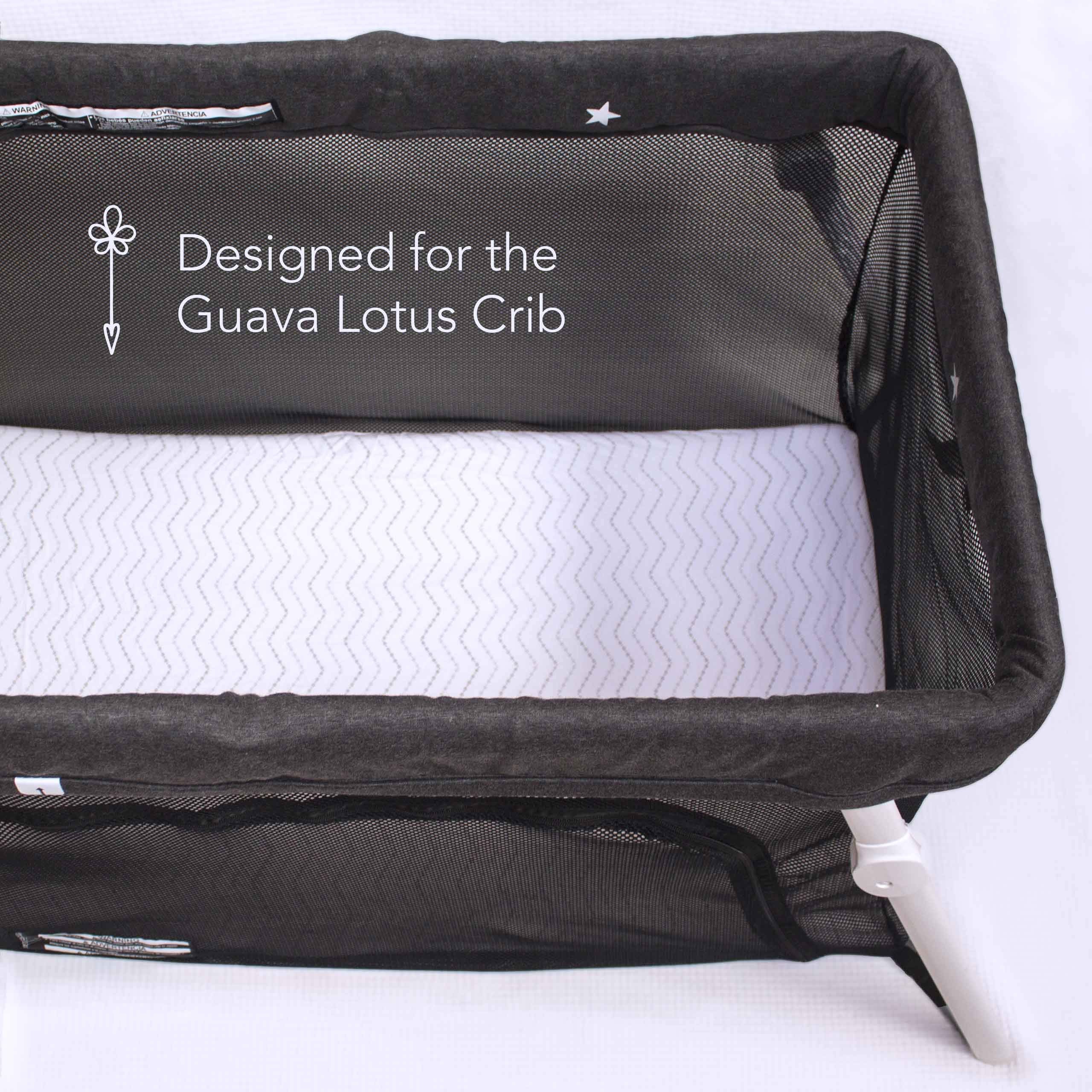 Luvberries Guava Lotus sheets on travel crib mattress provide secure fit and gentle comfort.