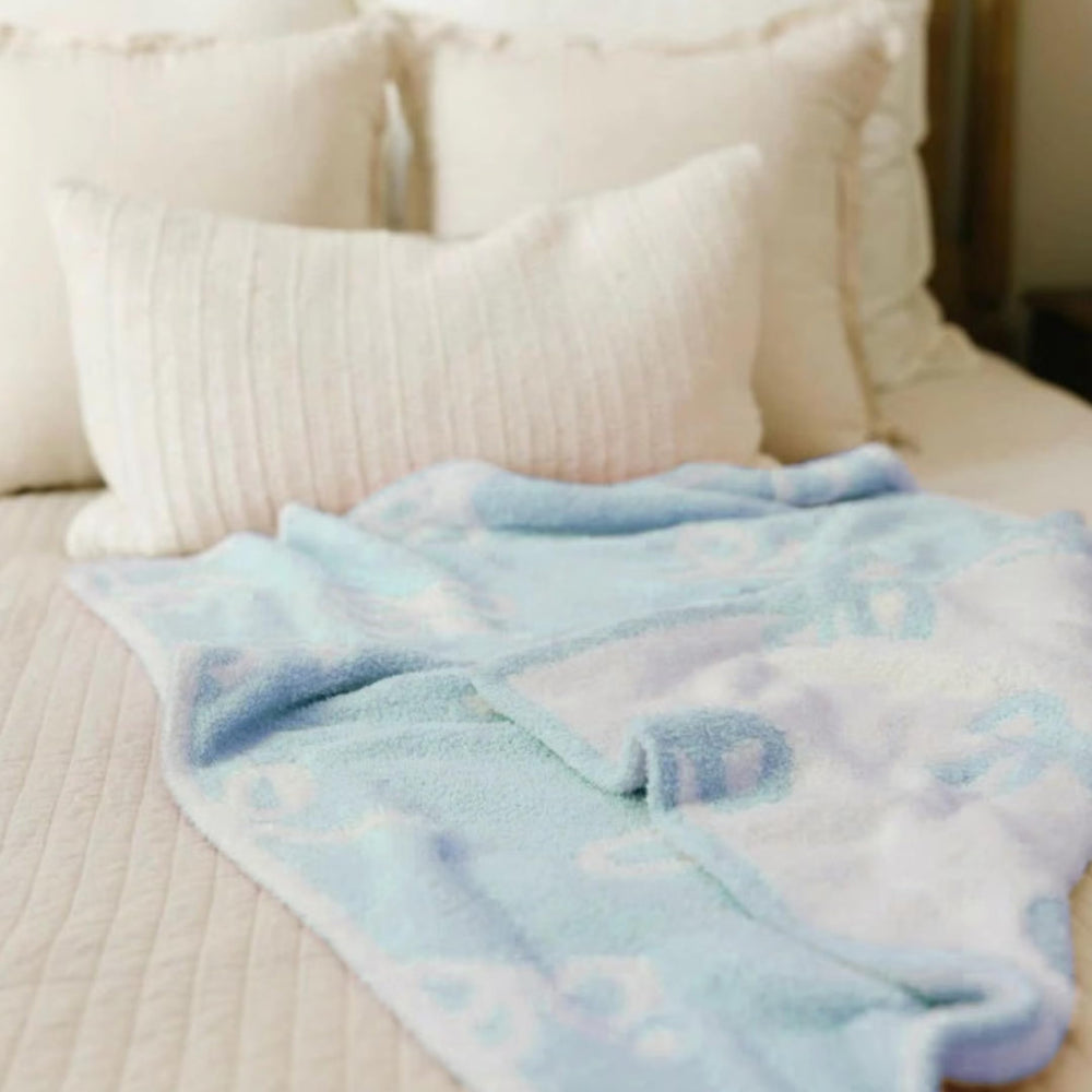 Luxape Bow Blanket blue bows detail fabric close shot emphasizes premium material.