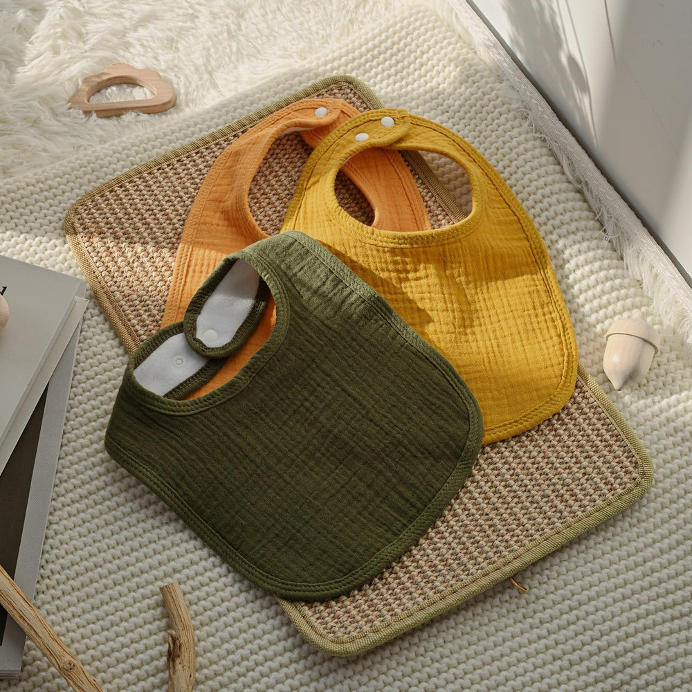 LYRICHOM BABY gift-ready bibs line in vibrant yellow packaging