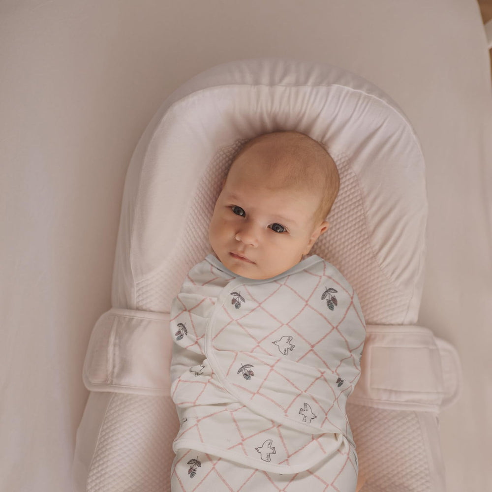 LYRICHOM BABY organic cotton swaddle wrap with adjustable wings enables secure, cozy newborn swaddling.