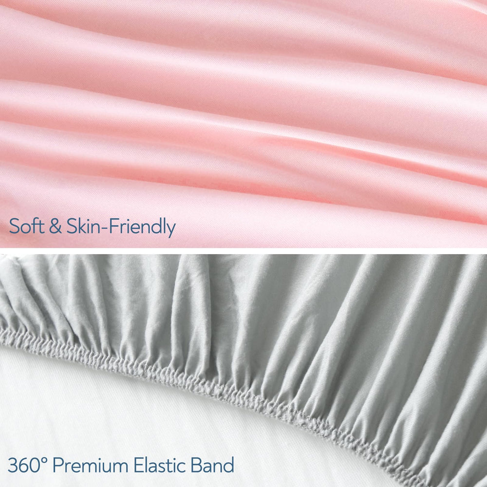 Magik & Kover Stretchy Crib Sheet grey-pink on mattress showing deep pocket
