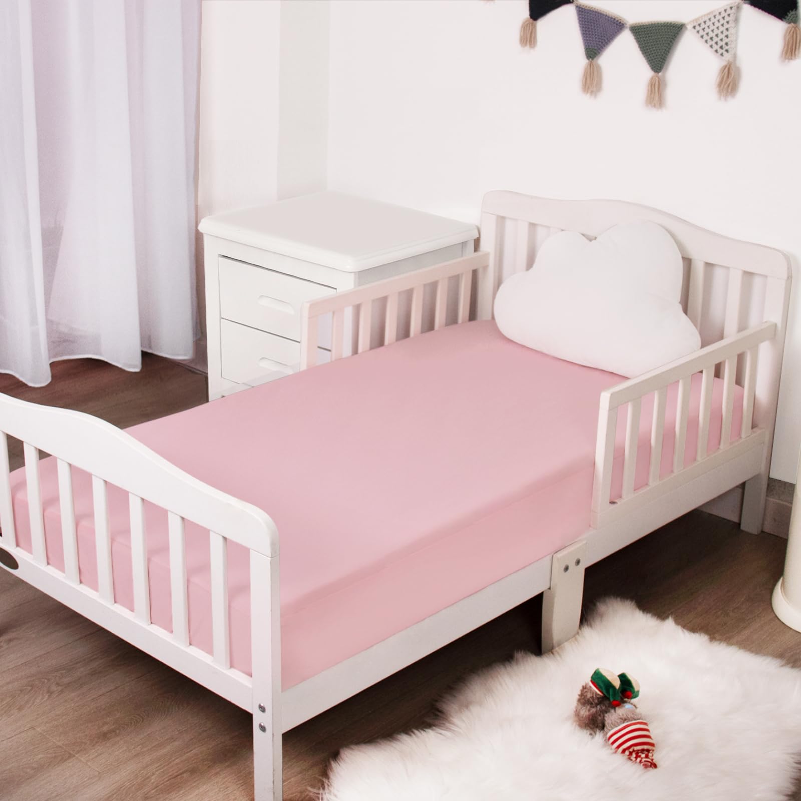 Magik & Kover pink fitted sheet in nursery scene conveys breathable comfort.