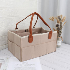 MaHonestFelt diaper caddy on changing table with easy-access pockets for diapers and wipes.