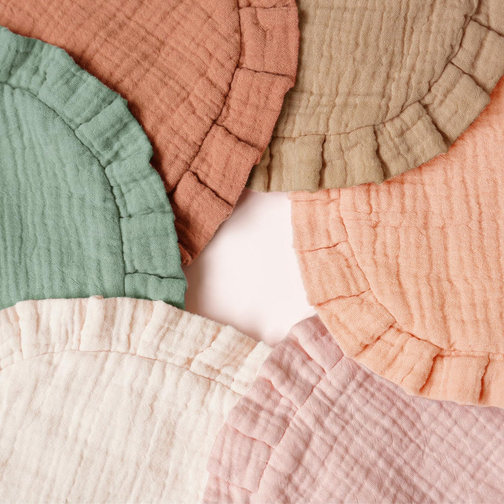 MairMore bib worn on baby neck shows coverage and comfort.