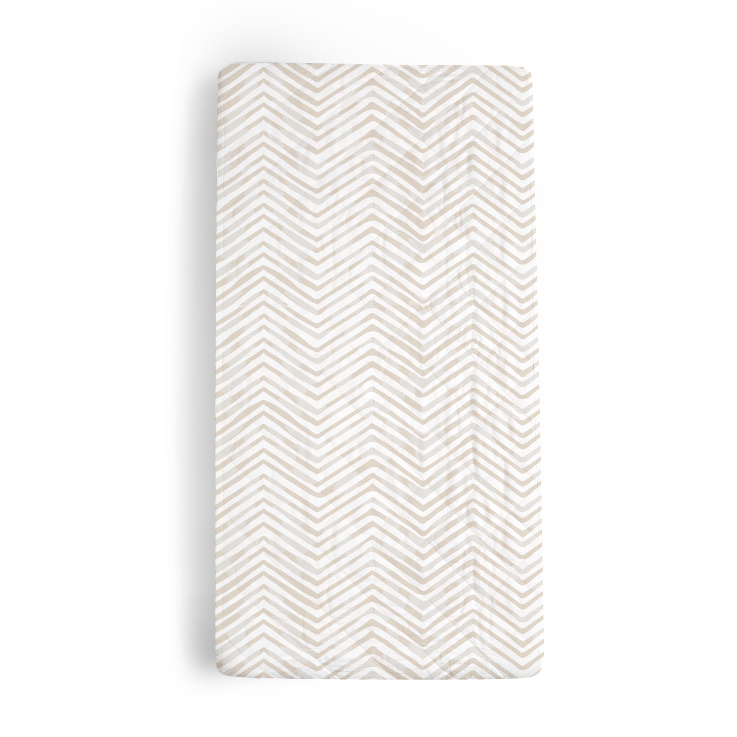 Makemake Organics changing pad cover in herringbone offers soft, skin-friendly comfort during diaper changes.