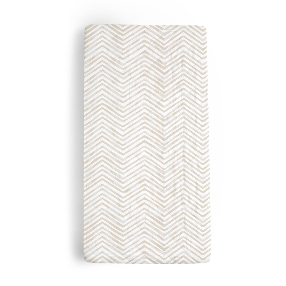 Makemake Organics changing pad cover in herringbone offers soft, skin-friendly comfort during diaper changes.