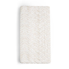 Makemake Organics changing pad cover in herringbone offers soft, skin-friendly comfort during diaper changes.