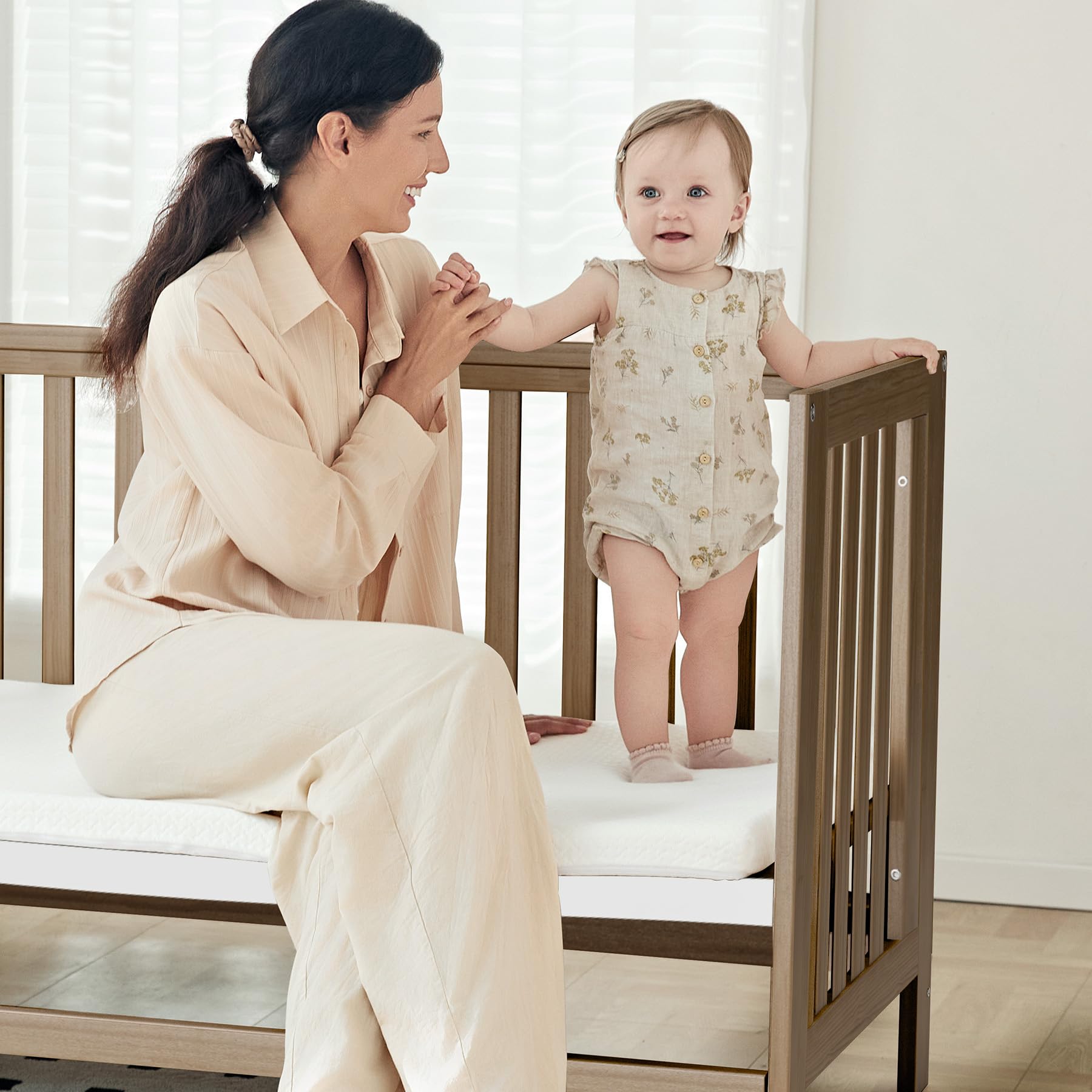 MAMAZING EvoNest adjustable-height crib demonstrates multiple mattress heights