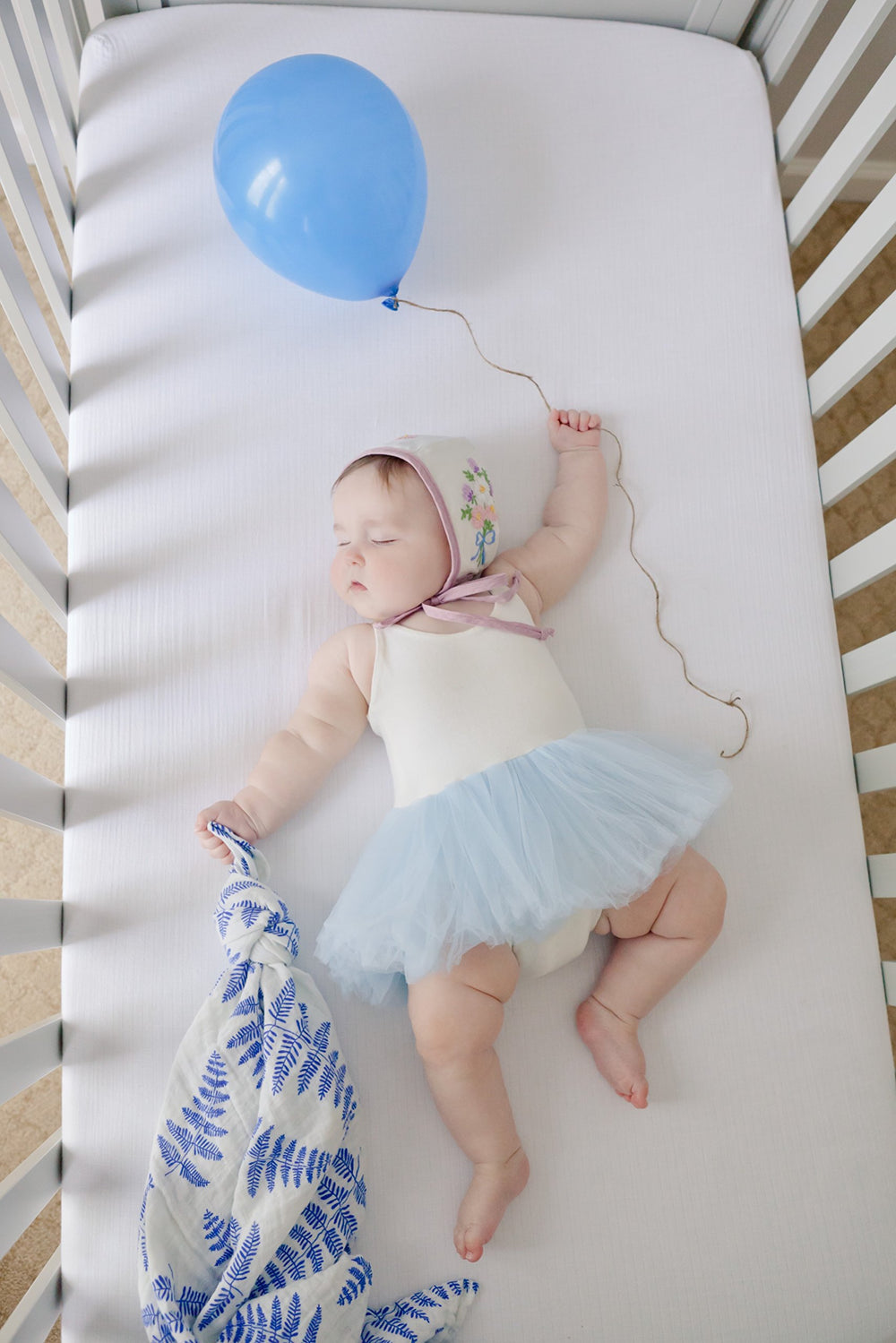 Margaux & May swaddle baby in arms, gentle fabric soothes baby during cuddle time.