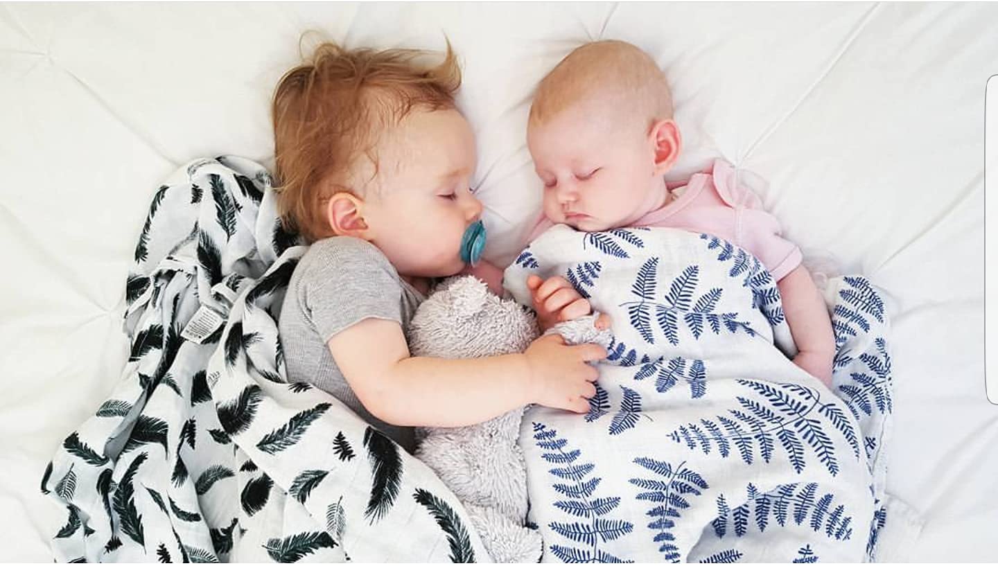 Margaux & May swaddle blanket green feather closeup, soft muslin ideal for gentle newborn sleep.