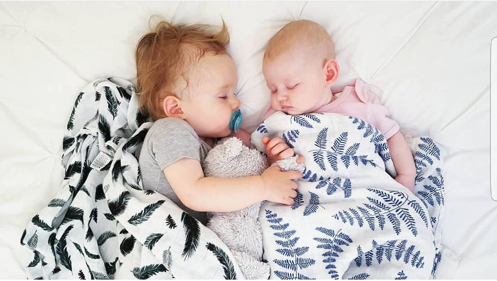 Margaux & May swaddle blanket green feather closeup, soft muslin ideal for gentle newborn sleep.