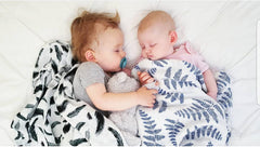Margaux & May swaddle blanket green feather closeup, soft muslin ideal for gentle newborn sleep.