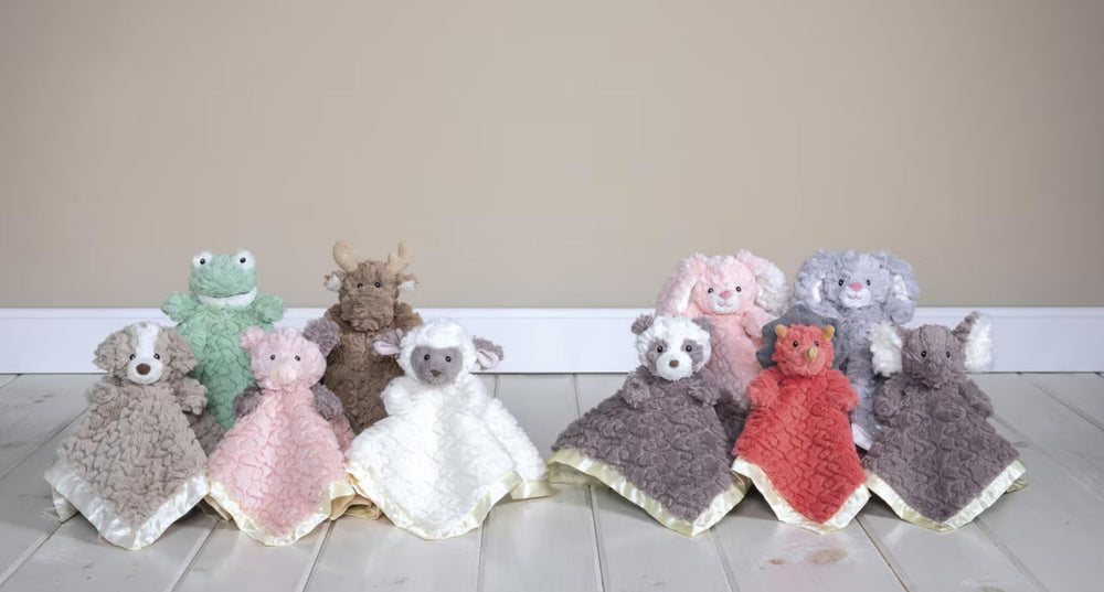 Mary Meyer Putty Nursery Piglet satin lining visible on blanket edge.