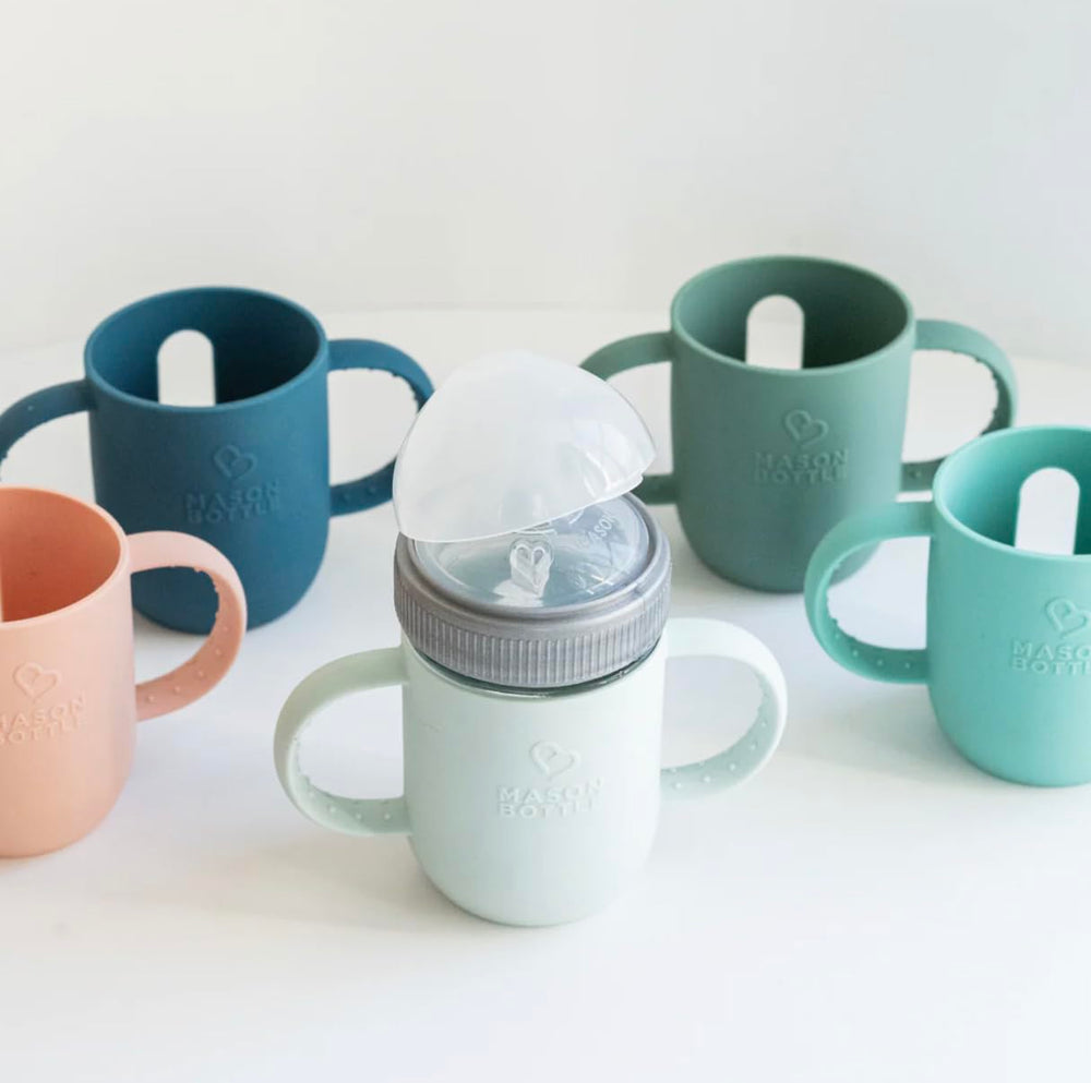 Mason Bottle silicone sleeve flexible material shown protecting glass during tumbles.