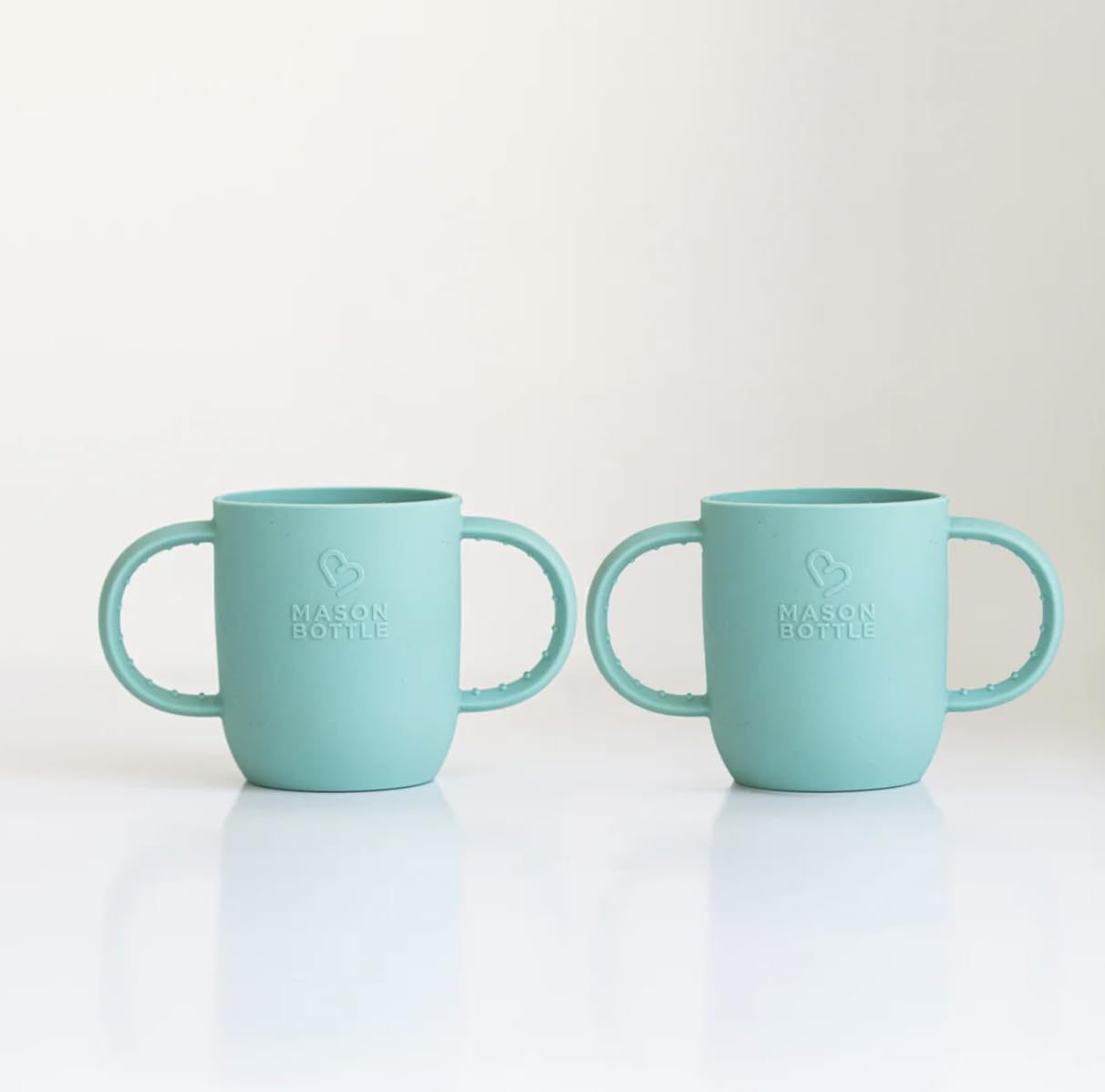 Mason Bottle handled silicone sleeve turquoise 8oz improves grip during infant feeding.