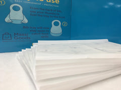MassiGoods compact travel bibs shown in a bag for on-the-go feeding
