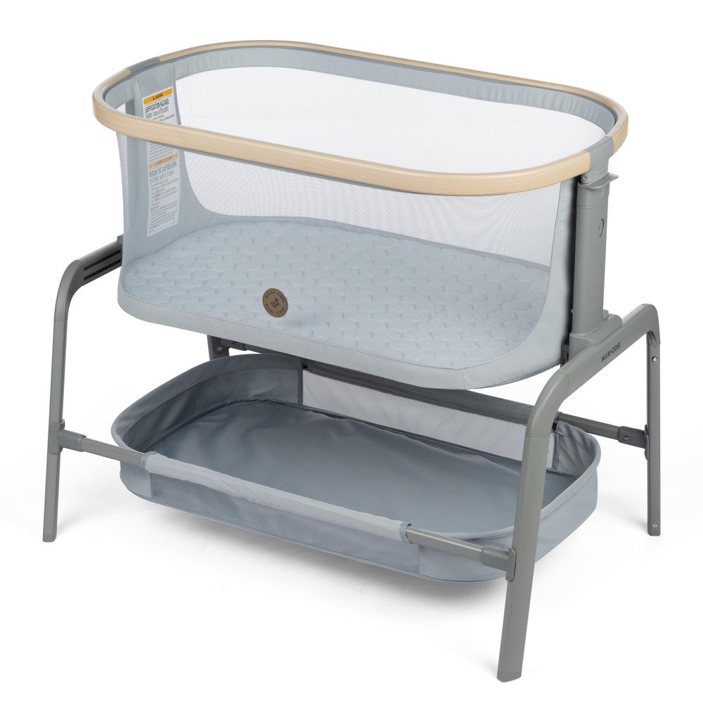 Maxi-Cosi Iora bassinet side view demonstrates portable bedside design for close baby proximity.