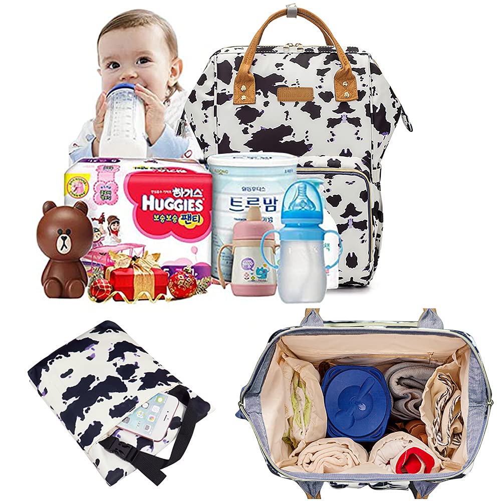 MCWTH cow-print diaper bag backpack rear-compartment view highlighting organized internal layout.