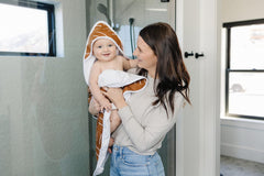 Mebie Baby mustard mudcloth pattern adds playful style to bath time routines.