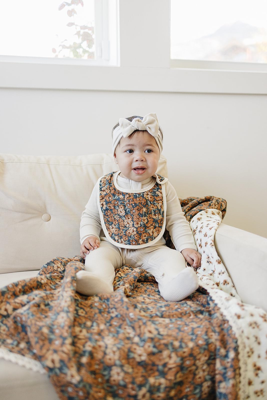 Freshly washed Mebie Baby muslin bibs with visible stitching and soft texture