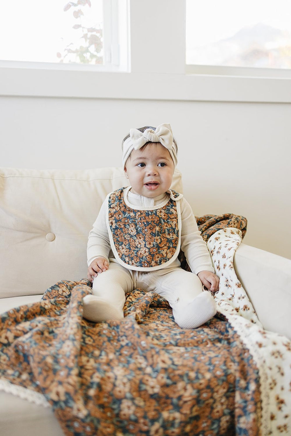 Freshly washed Mebie Baby muslin bibs with visible stitching and soft texture