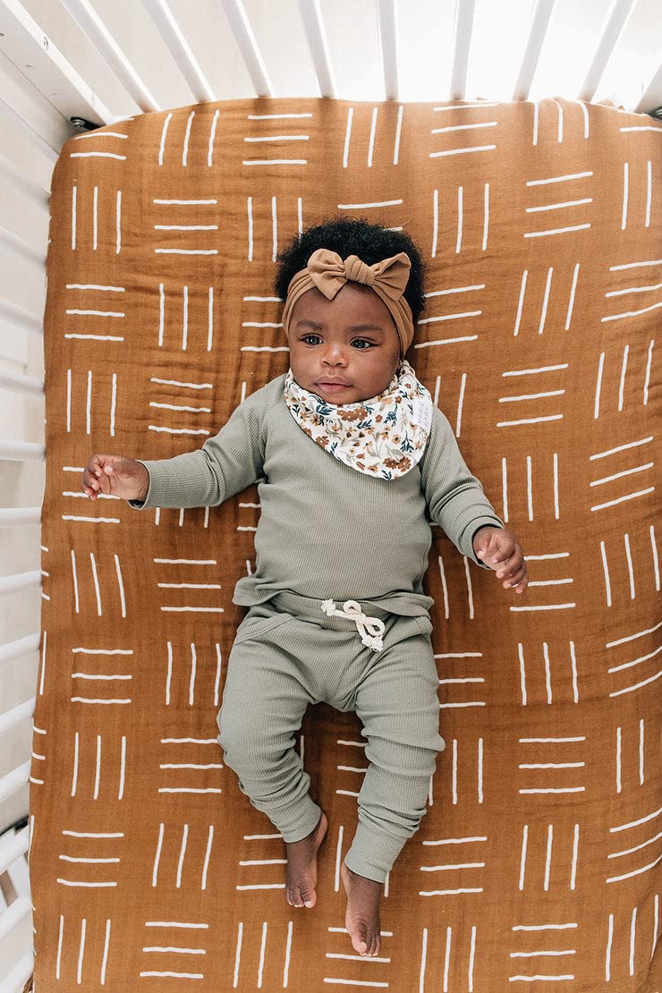 Mebie Baby floral bib worn by baby shows easy on and off.