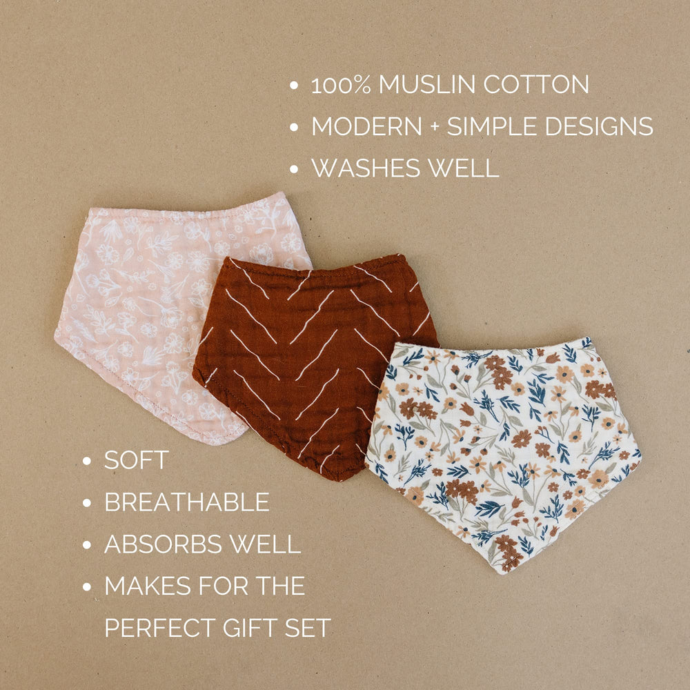 Mebie Baby floral bib on baby demonstrates machine washable practicality.