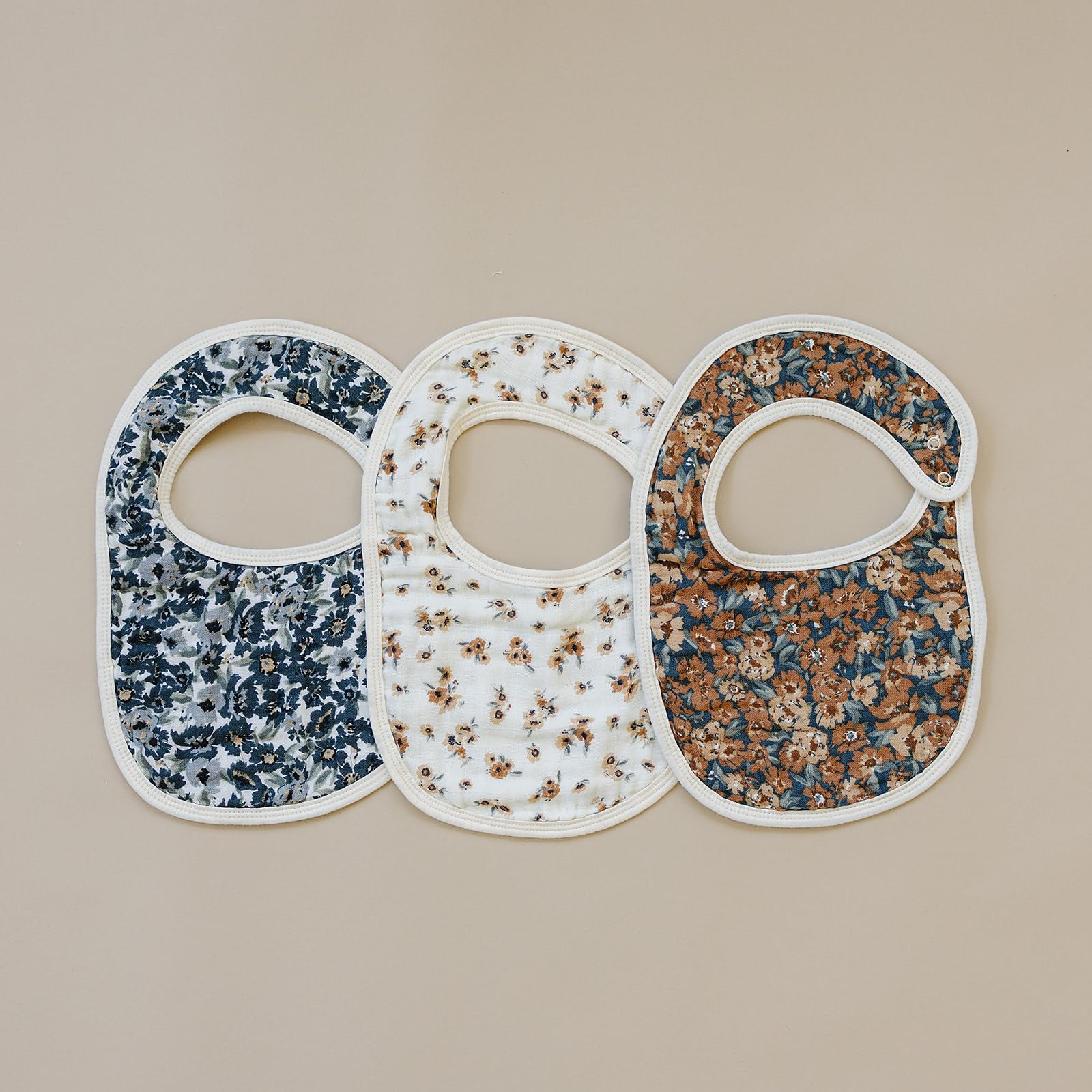 Close-up of Mebie Baby muslin bib in vintage floral showing breathable fabric