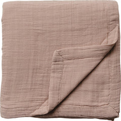 Mebie Baby muslin quilt folded in dusty rose for snuggly warmth and easy layering.