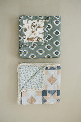 Mebie Baby muslin quilt folded in a tidy nursery scene for easy care.