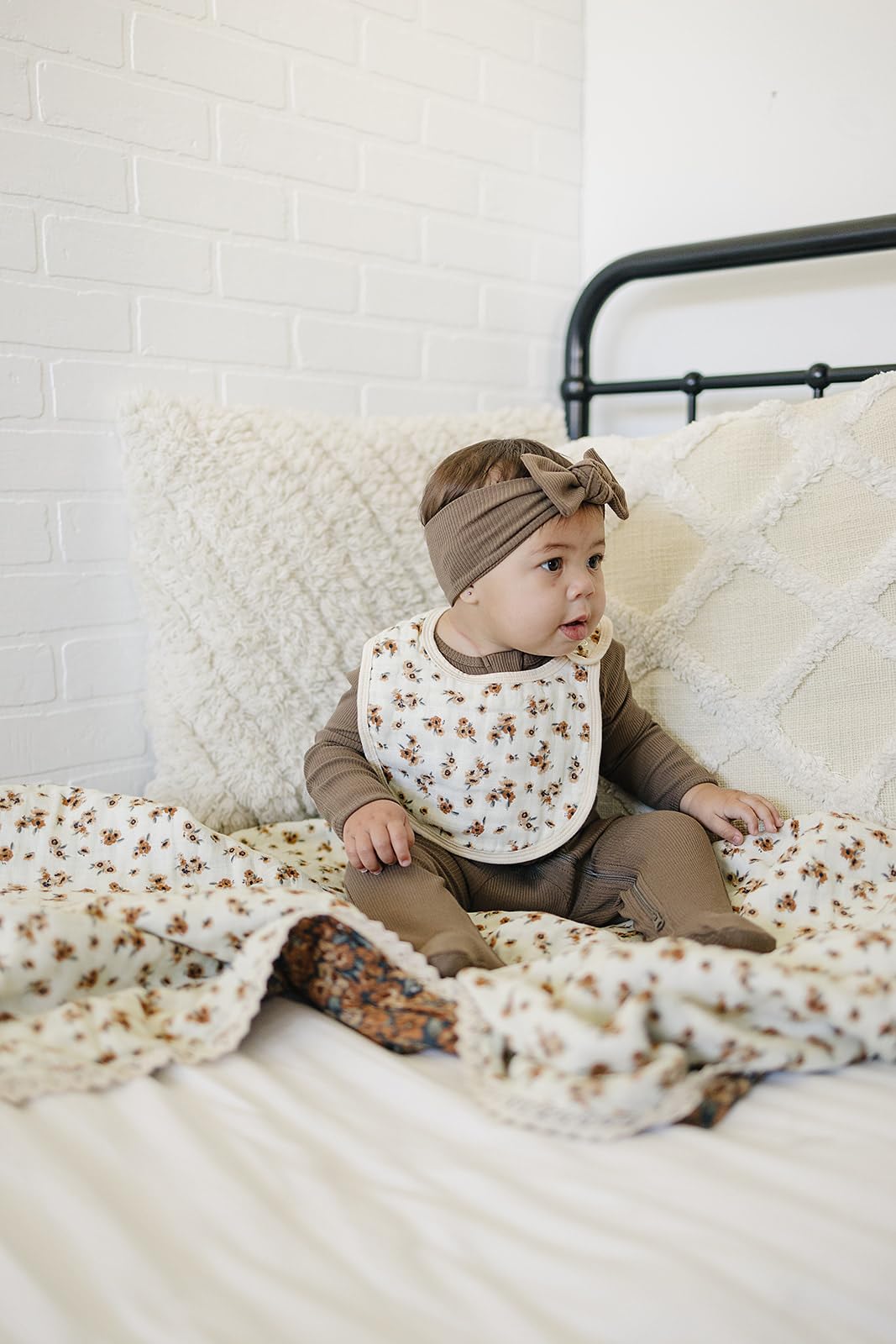 Mebie Baby muslin quilt beside washing machine, machine-washable cold, tumble dry low.