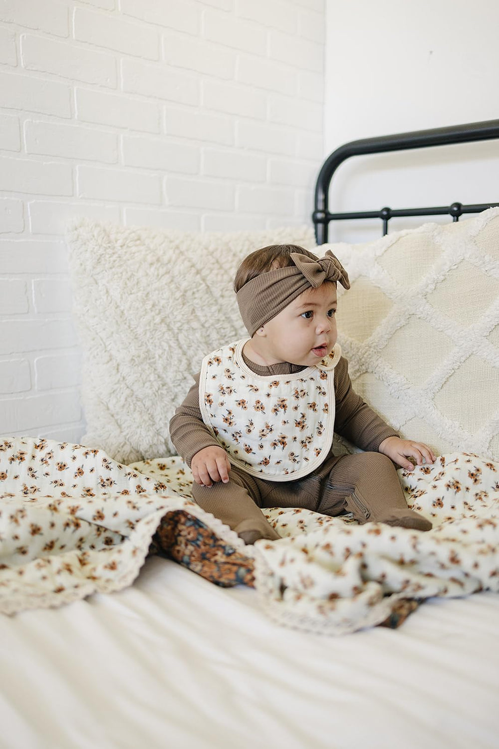 Mebie Baby muslin quilt beside washing machine, machine-washable cold, tumble dry low.