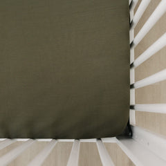 Mebie Baby Stretch Sheet Olive closeup showcases soft bamboo-blend fabric for cozy crib comfort.