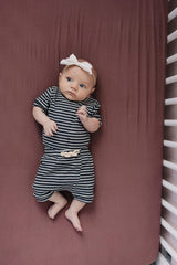 Mebie Baby Stretch Sheet Plum fitted edge demonstrates secure fit for easy nightly changes.