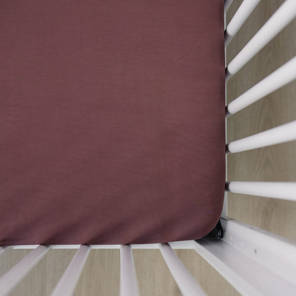 Mebie Baby Stretch Sheet Plum top view showing a snug crib fit for calm naps.