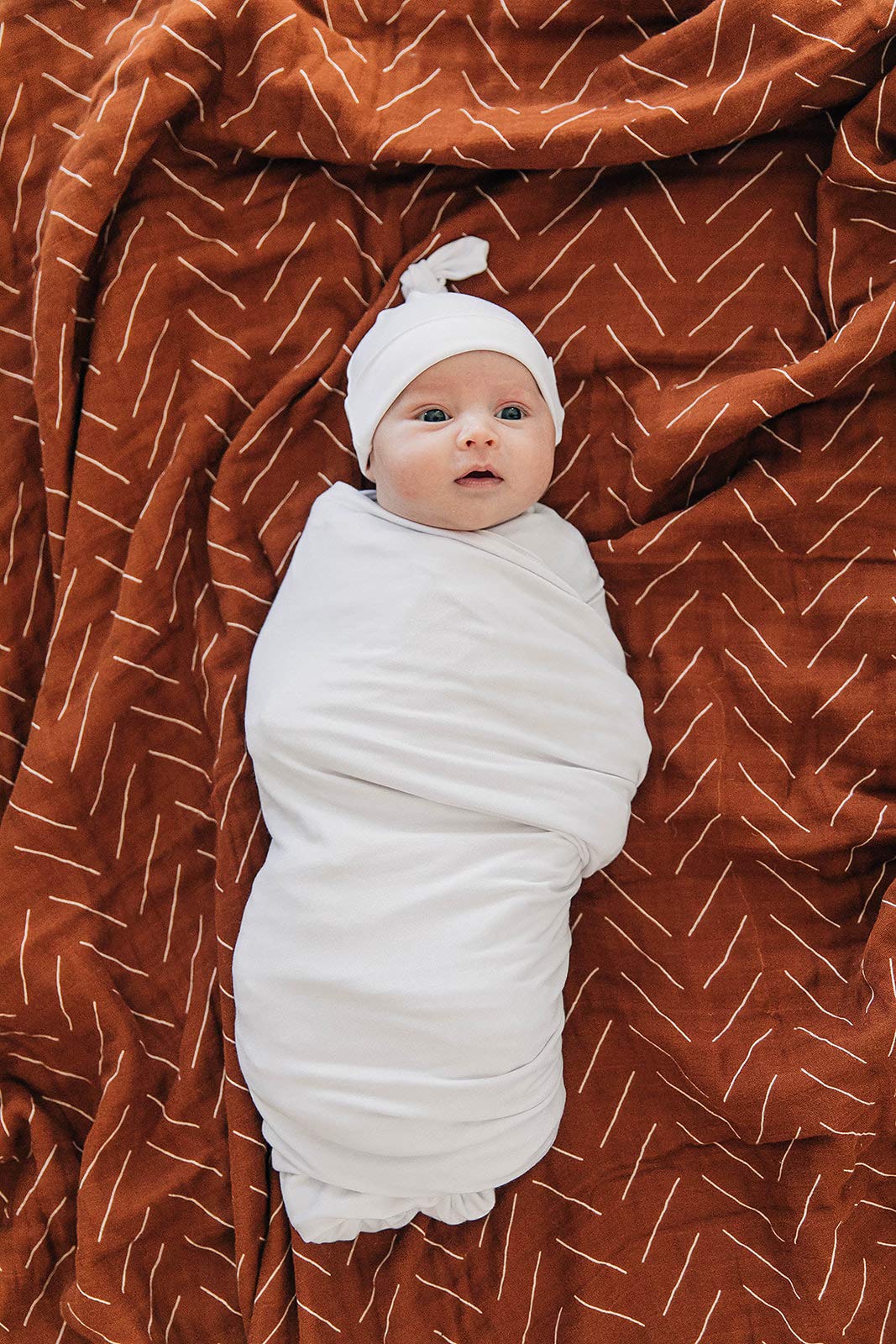 Mebie Baby versatile swaddle wrap shown as wrap and light blanket.
