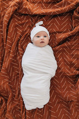 Mebie Baby versatile swaddle wrap shown as wrap and light blanket.
