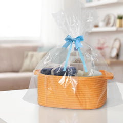 MEGASKET orange woven basket in nursery setup for diapers and toys.