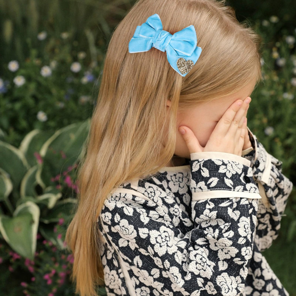 Melyde blue velvet bow on an alligator clip provides secure, all-day hold.