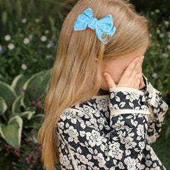Melyde blue velvet bow on an alligator clip provides secure, all-day hold.
