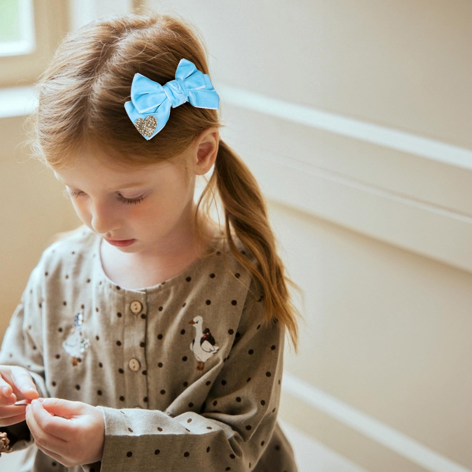 Melyde velvet bow close-up in blue highlights craftsmanship and heart detail.