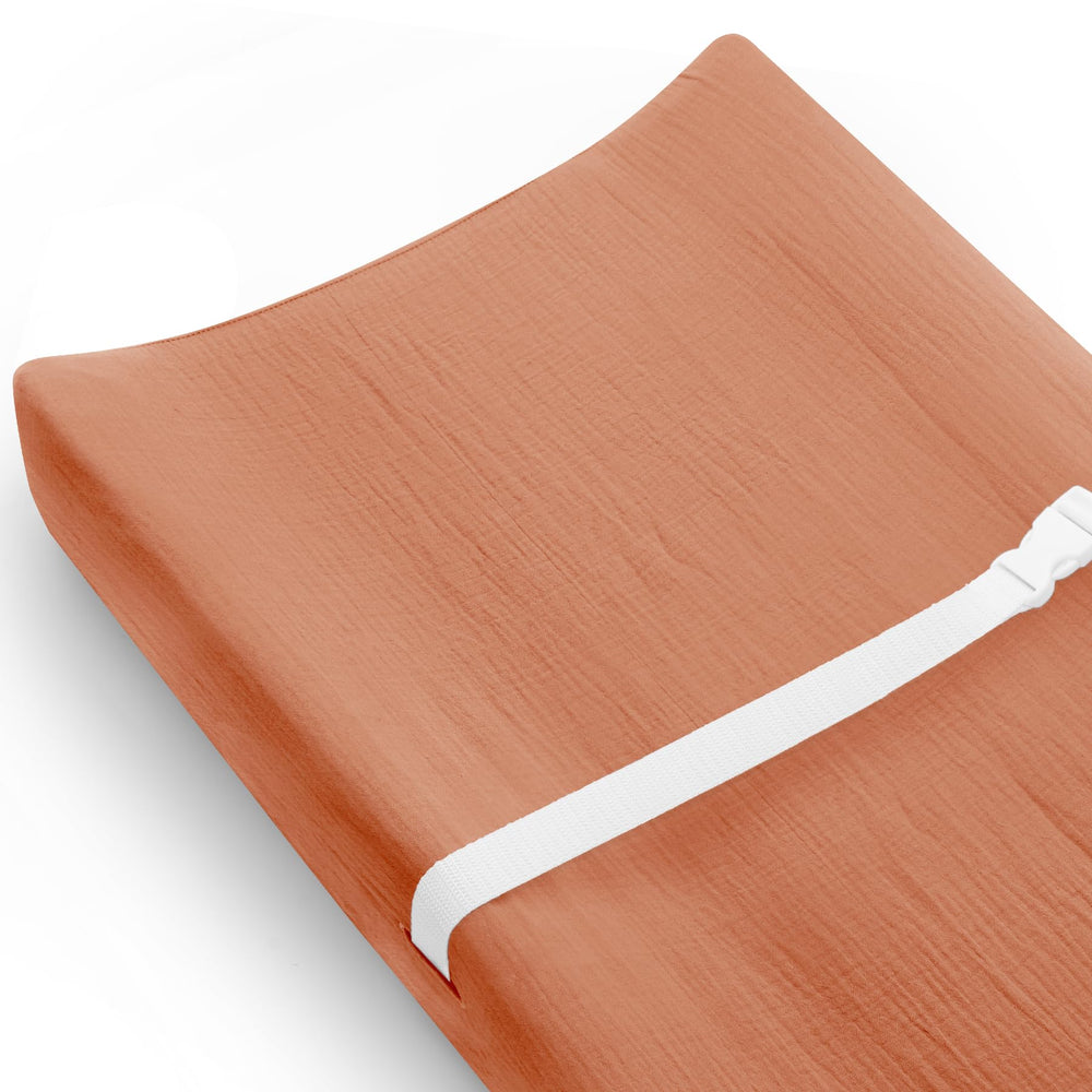 Meowcards changing pad cover in brick front view showing soft, breathable muslin for baby comfort
