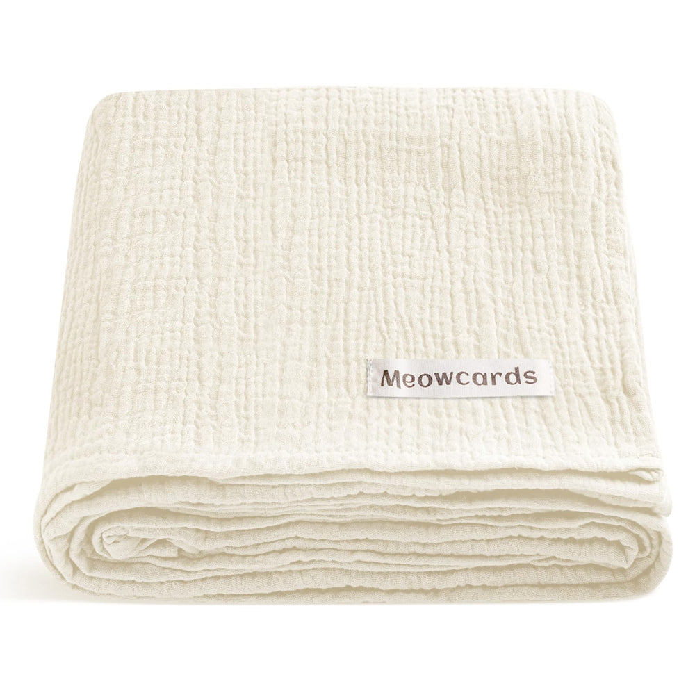 Meowcards muslin swaddle pale yellow folded for easy storage and quick setup