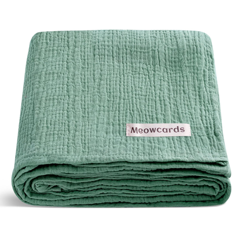 Meowcards muslin swaddle: closeup of soft double muslin for gentle baby comfort.